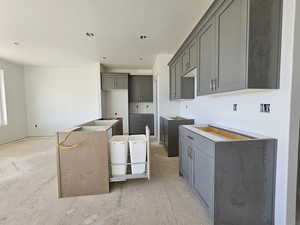 Kitchen featuring a kitchen island and gray cabinetry