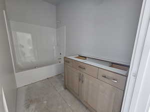 Bathroom featuring washtub / shower combination and vanity