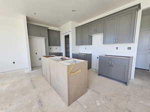 Kitchen featuring gray cabinets and a kitchen island