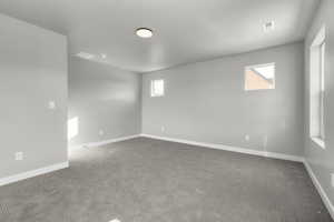 Unfurnished room with dark colored carpet