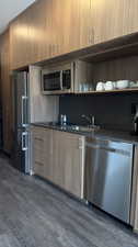 Kitchen featuring dark hardwood / wood-style floors, sink, and stainless steel appliances