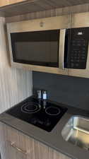 Room details featuring sink and black electric stovetop