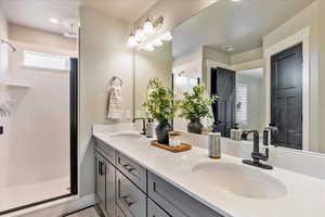 Primary Bathroom with a shower and vanity