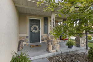 Doorway to property with covered porch