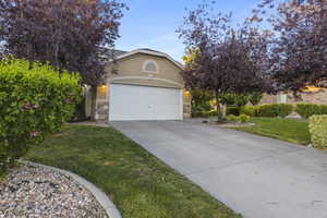 View of front facade with a garage and a front lawn