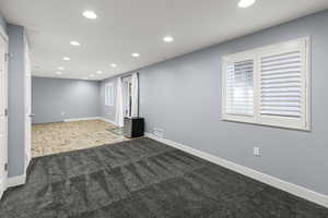 Large Spacious Basement plumbed for a kitchenette or wet bar with custom tile flooring and newer carpet