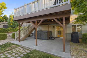 Walkout basement entrance to Patio with Hot Tub and Under-Deck Lighting