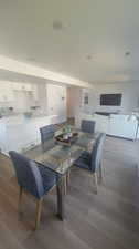 Dining area with hardwood / wood-style floors