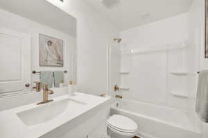 Full bathroom featuring vanity, tub / shower combination, and toilet