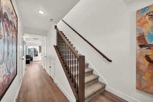 Staircase with hardwood / wood-style floors