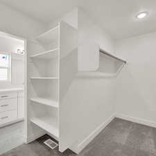 Walk in closet featuring carpet floors