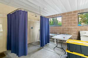 Interior space with concrete floors and brick wall