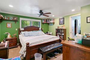 Bedroom featuring carpet floors, crown molding, and ceiling fan