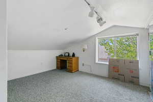 Bonus room featuring carpet floors and vaulted ceiling