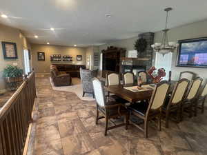 Tiled formal dining room with a notable chandelier and a textured ceiling