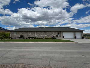 Single story home with a 3 garage and a front yard