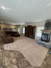 Living room with a textured ceiling and plenty of natural light