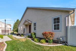 View of front of property featuring a garage and a front yard