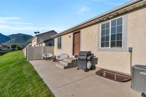 View of patio featuring cooling unit, grilling area, and a mountain view