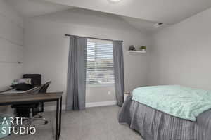 Bedroom with carpet and vaulted ceiling