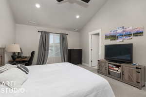 Primary Bedroom with high vaulted ceiling, ceiling fan, and light colored carpet