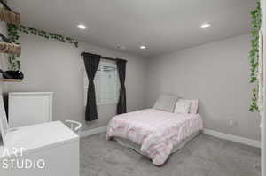 Bedroom featuring light colored carpet