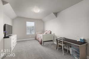 Carpeted bedroom with lofted ceiling