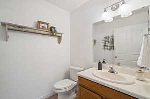 Bathroom featuring vanity, toilet, and tile patterned floors