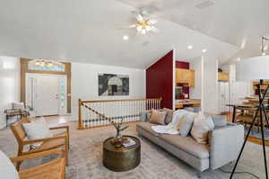 Living room with ceiling fan and vaulted ceiling