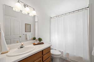 Bathroom with vanity, tile patterned floors, and toilet