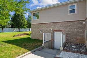 View of side of property featuring a yard