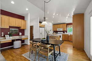 Dining room featuring light hardwood / wood-style floors and vaulted ceiling