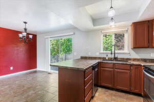 Kitchen with sink, stainless steel dishwasher, light tile patterned floors, and pendant lighting