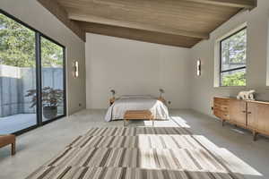 Unfurnished bedroom featuring lofted ceiling with beams, carpet floors, access to outside, and wood ceiling