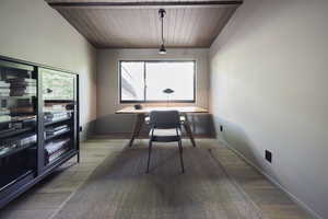 Dining room featuring wood-type flooring and wooden ceiling