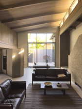 Living room with lofted ceiling with beams and wooden ceiling