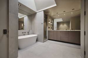 Bathroom featuring tile patterned flooring, tile walls, independent shower and bath, and double sink vanity