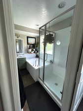 Primary Bathroom featuring soaking tub and shower