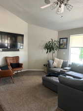 Great room / living room featuring ceiling fan, and lofted ceiling