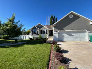 Attractive home featuring large 2-car garage and beautiful landscaping