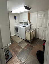 Spacious laundry room with white cabinetry and tile floor