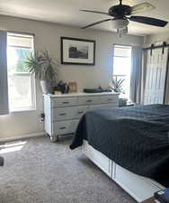 Main floor Primary Bedroom with great natural light, ceiling fan