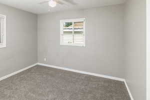 Unfurnished room featuring carpet floors and ceiling fan