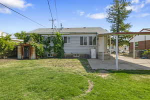 Rear view of property with a patio, cooling unit, a shed, and a yard