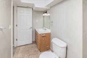 Bathroom featuring tile patterned flooring, toilet, and vanity