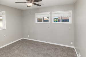 Carpeted empty room with ceiling fan