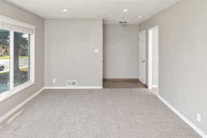 Spare room featuring carpet flooring