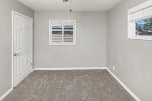 Carpeted spare room with ceiling fan