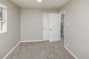 Unfurnished bedroom with carpet floors