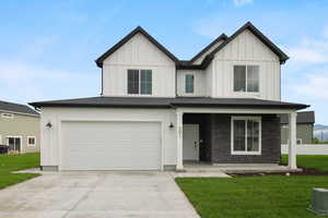 View of front of home featuring a garage and a front lawn